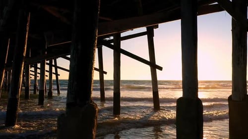 Flying under the Newport Beach pier viewing the sun as it sets