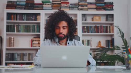 Man Working at Home Office Desk with Laptop