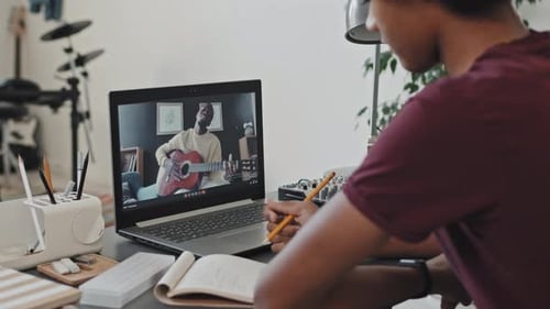Student Takes Guitar Lesson Over Laptop