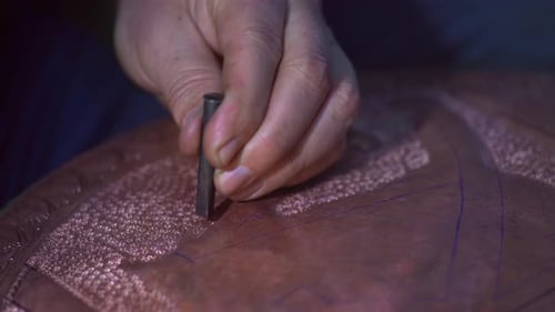 Metalworker Shaping Copper Bowl with Hammer