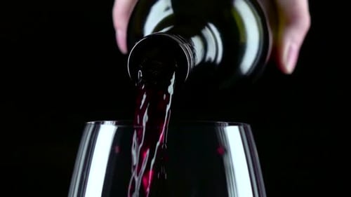 Red Wine Pouring into Glass Close Up