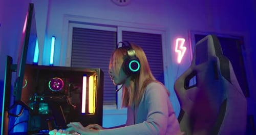 Young Adult Gaming on Computer at Night