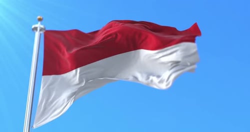 Indonesia Flag Waving Against Clear Blue Sky