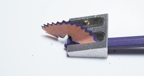 Sharpening a Blue Pencil with Silver Sharpener
