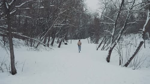 Man Running in Winter Forest in Slow Motion