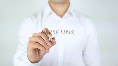 Man Writes Marketing Idea on Clear Surface