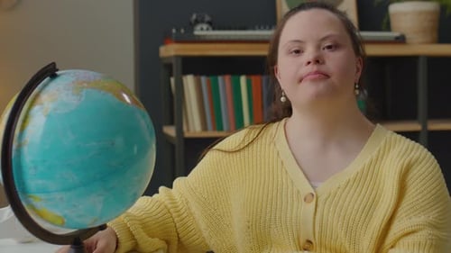 Smiling Woman with Globe in Interior Room