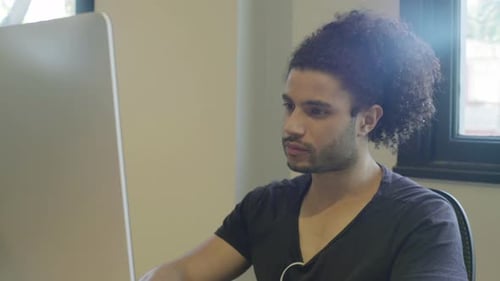 Young man using desktop computer