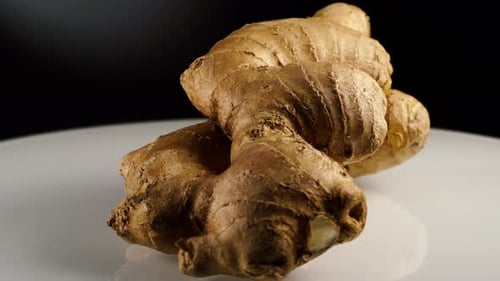 Rotating Ginger Root on White Reflective Surface