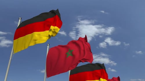 Morocco and Germany National Flags Waving on Flagpoles