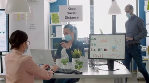 Team Workers with Protection Face Masks Working in Business Office