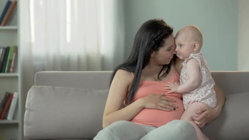 Cheerful Pregnant Woman Hugging Cute Little Baby Girl, Love and Tenderness