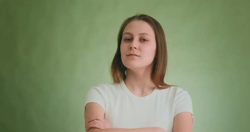 Pretty Proud Lady with Long Blonde Hair on Green Background