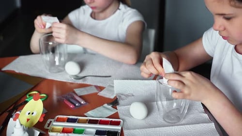 Girls Decorating Eggs With Tissue Paper and Paint