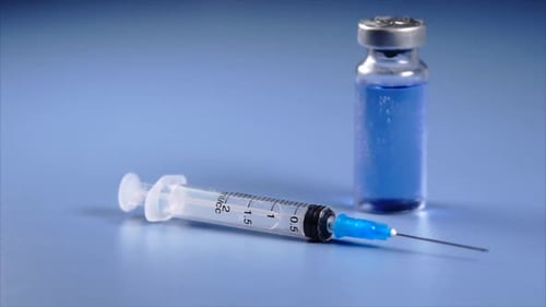 Close Up View of Ampoule and Syringe with Selective Focus.