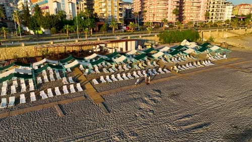 Empty sun loungers on the beach aerial view 4 K Turkey Alanya