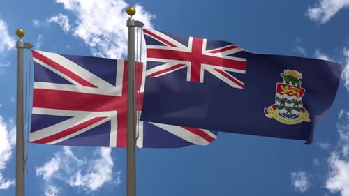 Union Jack and Cayman Islands Flags Waving in Blue Sky