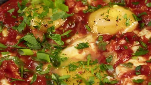 Close Up of Shakshuka with Eggs and Herbs