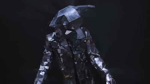 Dancer in Geometric Mirror Suit Moving in Dark