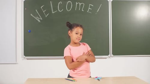 African Girl Posing on Chalk Board. Black Schoolgirl in Classroom