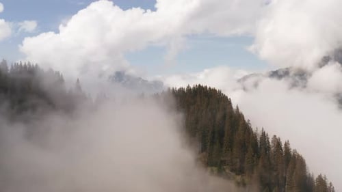 Aerial of mountain top surrounded by clouds