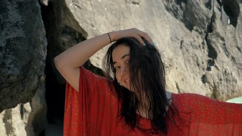 Attractive Young Woman Posing on Beach Rocks