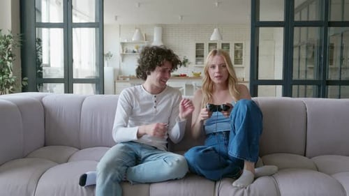 Couple Relaxing at Home Playing Video Game