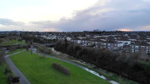 Aerial - Fly towards houses over the grass at the park. Somewhere in Dublin, Ireland.