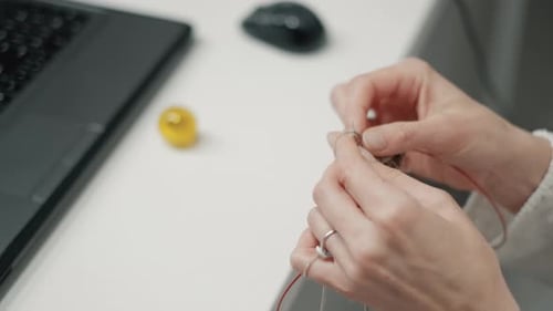 The Mature Woman Knitting in the Office. Woman Knitting and Sitting in the Office While Having a