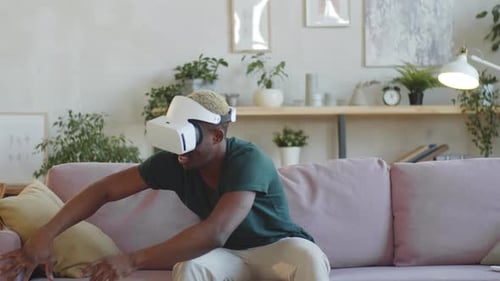 Man Experiences Virtual Reality on Couch at Home