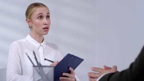 Blonde Woman Taking Notes in Office Setting