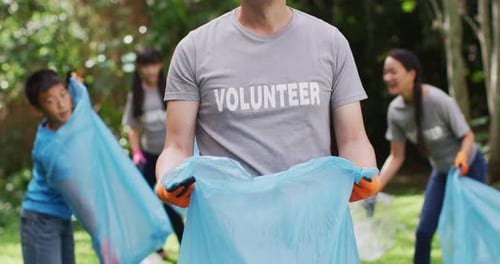 Enthusiastic Volunteers Work Together Cleaning Park Litter