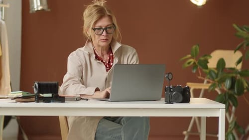 Woman Working on Laptop in Studio