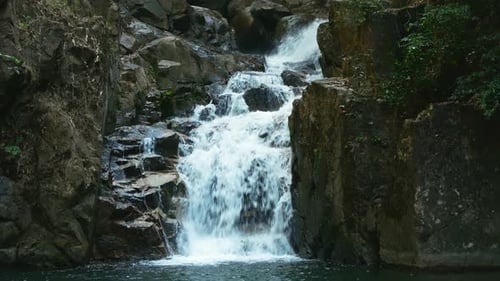 Waterfall Cascading Down Rocks in Tropical Nature