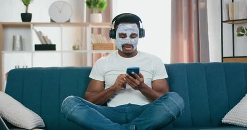 Young Adult with Face Mask Listening to Music