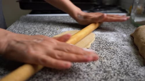 Baker Flattening And Cutting Pastry Dough - Close up shot