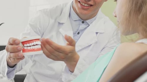 Dentist Explains Dental Procedure to Patient