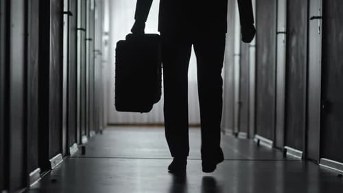 Silhouette of Businessman Leaving Hotel