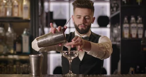 Bartender Preparing Cocktail Drink at Upscale Bar