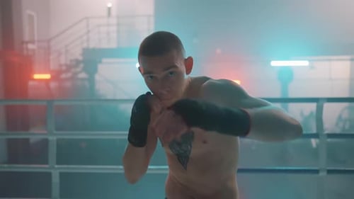 Young Man Boxing Training in a Ring