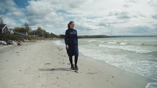 Caucasian Woman Wearing Sneakers and Walking on the Sandy Shores of the Beach