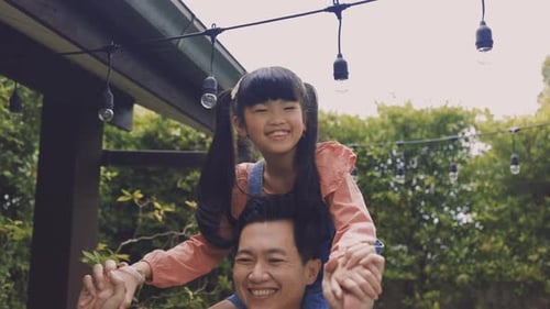 Happy Father Giving Daughter Piggyback Ride Outdoors