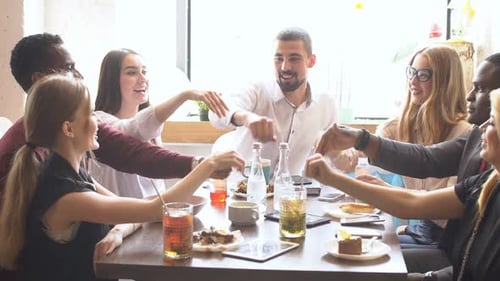 Friends Laughing Together at Cafe Table