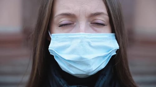Portrait of a Young Woman Wearing Protective Mask on the Street