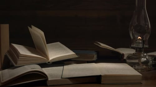 Antique Lamp Illuminates Books in Dark Room