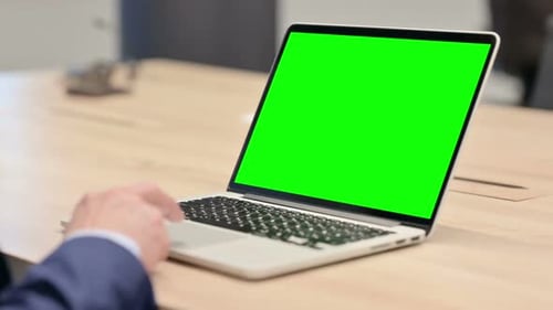 Laptop with Green Screen in Office Setting