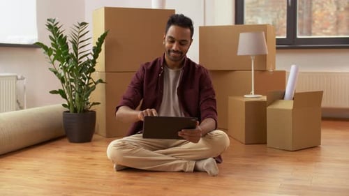 Man with Tablet Pc and Boxes Moving To New Home 8