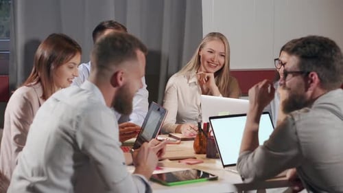 Business Colleagues Meeting at Table with Laptops