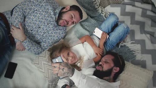 Gay Couple Taking Selfies With Daughter