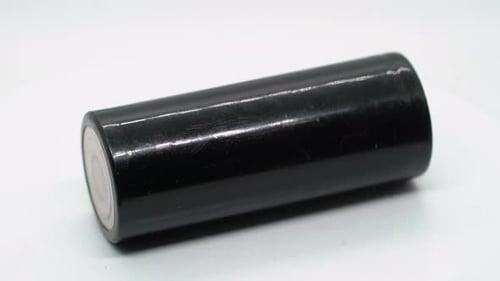 Black Battery Lying on White Surface